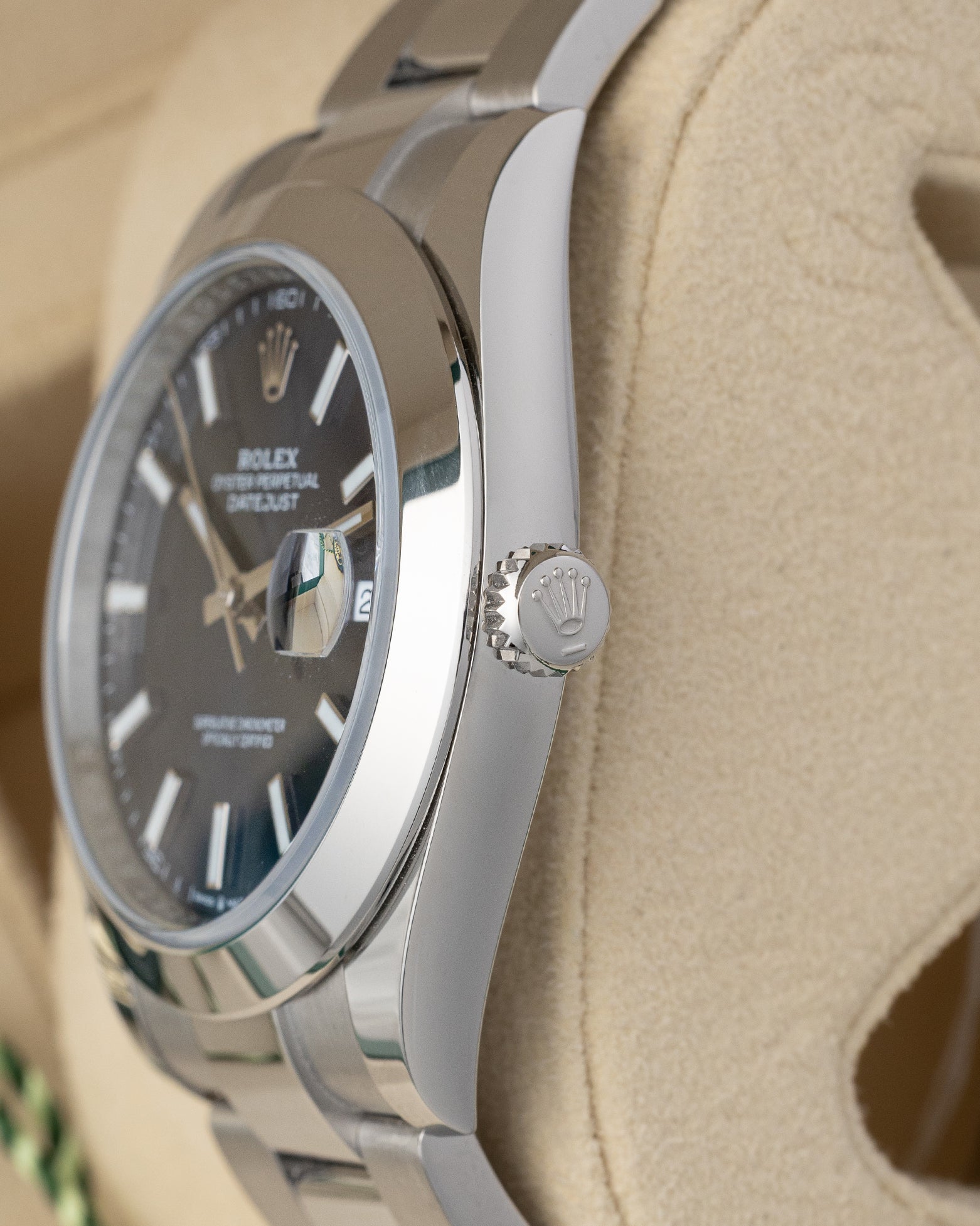 close-up view of the right side profile of a Rolex Datejust 41 case, showcasing the polished smooth bezel and the winding crown