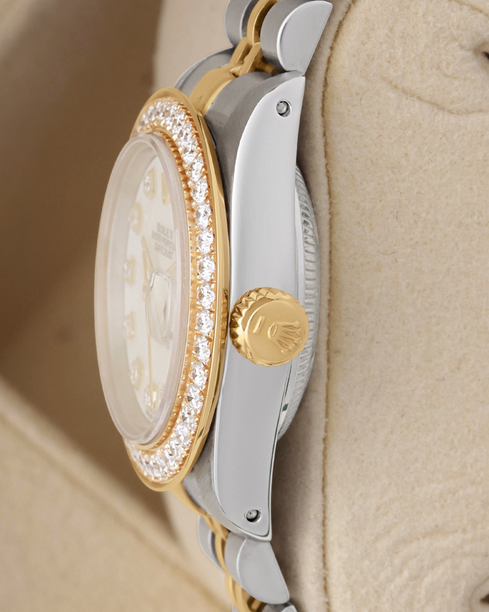 Side profile view of a two-tone Rolex Lady-Datejust 69173 showing the custom yellow gold diamond bezel and signed fluted gold crown