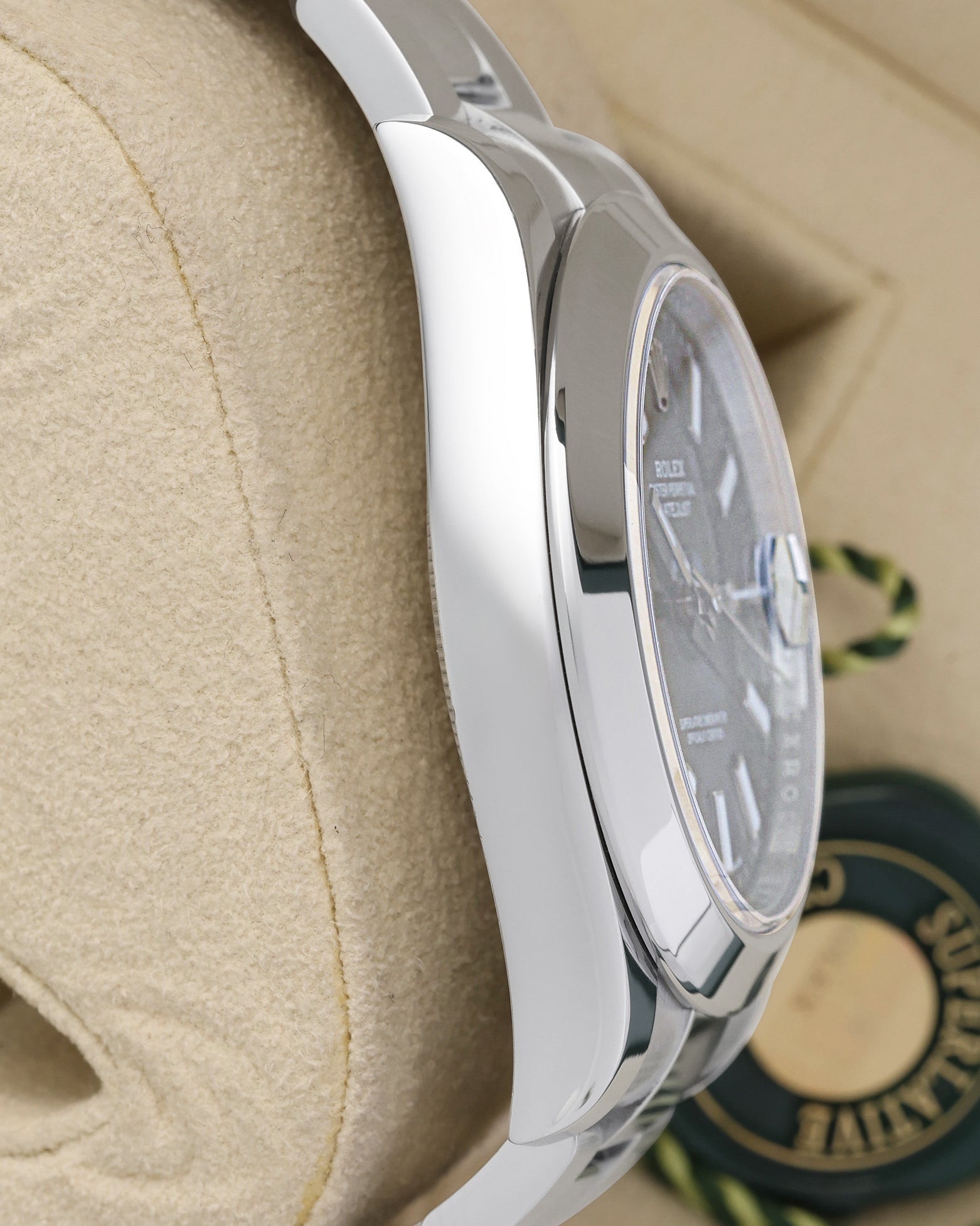 left-side case profile view of a pre-owned 41mm stainless steel Rolex Datejust II Oyster case resting on a presentation cushion
