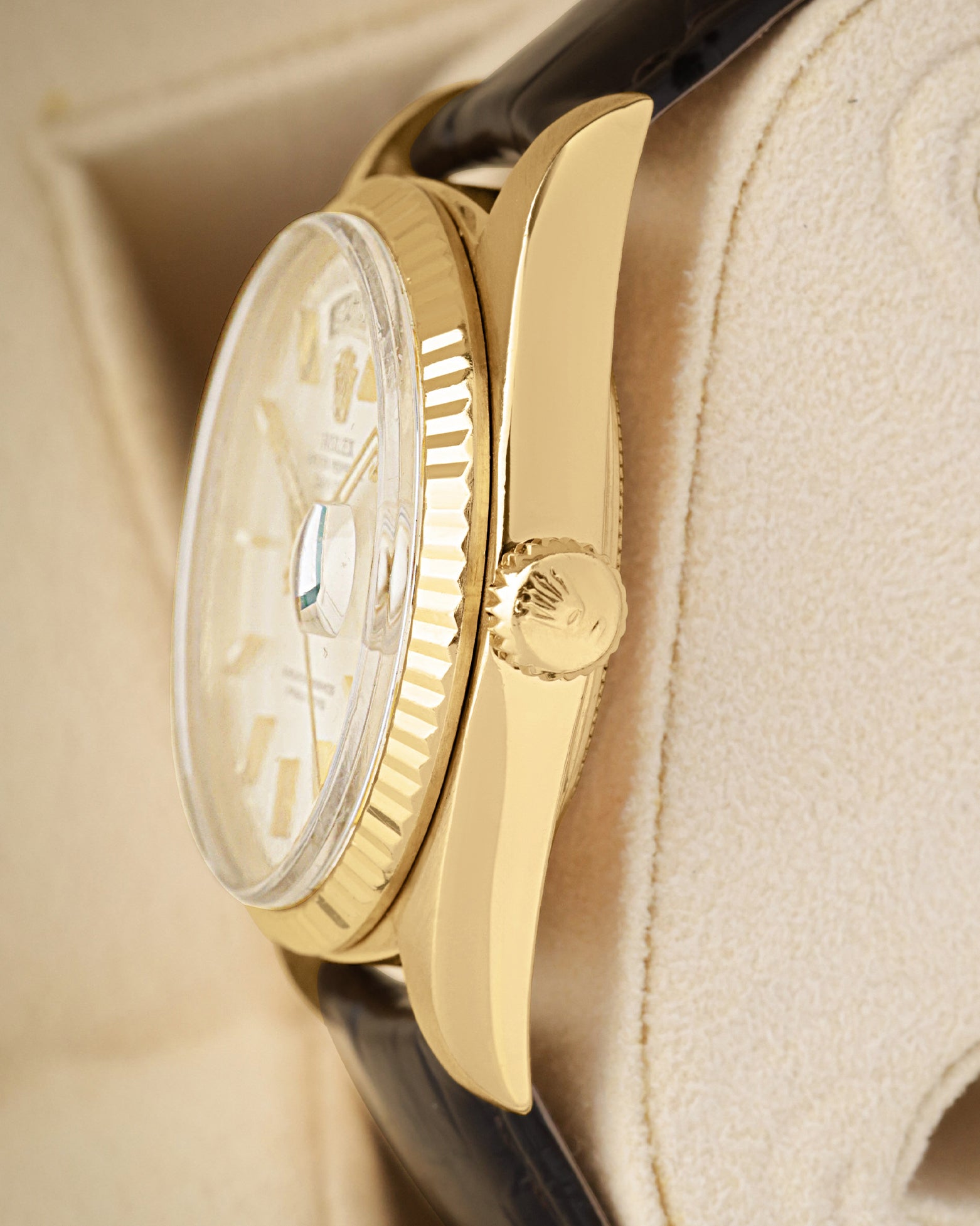 Side profile highlighting the 18k yellow gold case construction, acrylic crystal, and signature screw-down winding crown on a vintage Rolex 1803