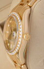 Close-up right profile view of the heavy gold watch head highlighting the smooth profile of the sapphire crystal, brilliant diamond settings, and the fluted 18k yellow gold Twinlock winding crown