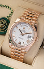 A high-angle three-quarter portrait of the 40mm rose gold luxury watch case highlighting the reflection across its 18k fluted bezel and integrated Presidential links