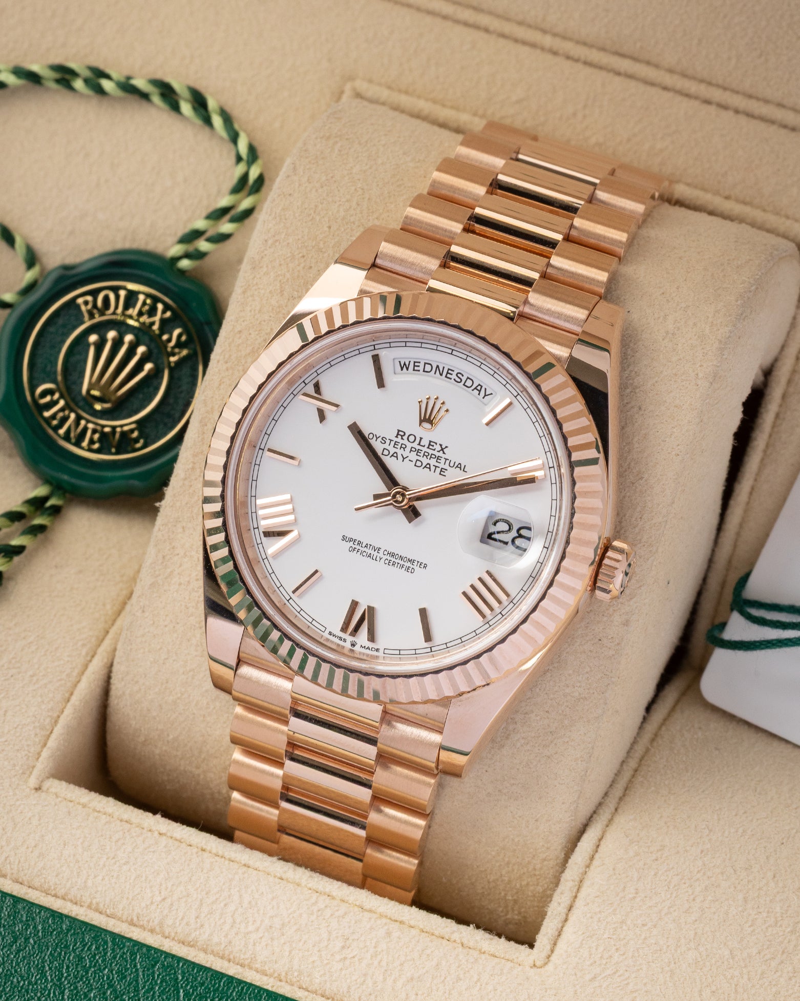 A high-angle three-quarter portrait of the 40mm rose gold luxury watch case highlighting the reflection across its 18k fluted bezel and integrated Presidential links