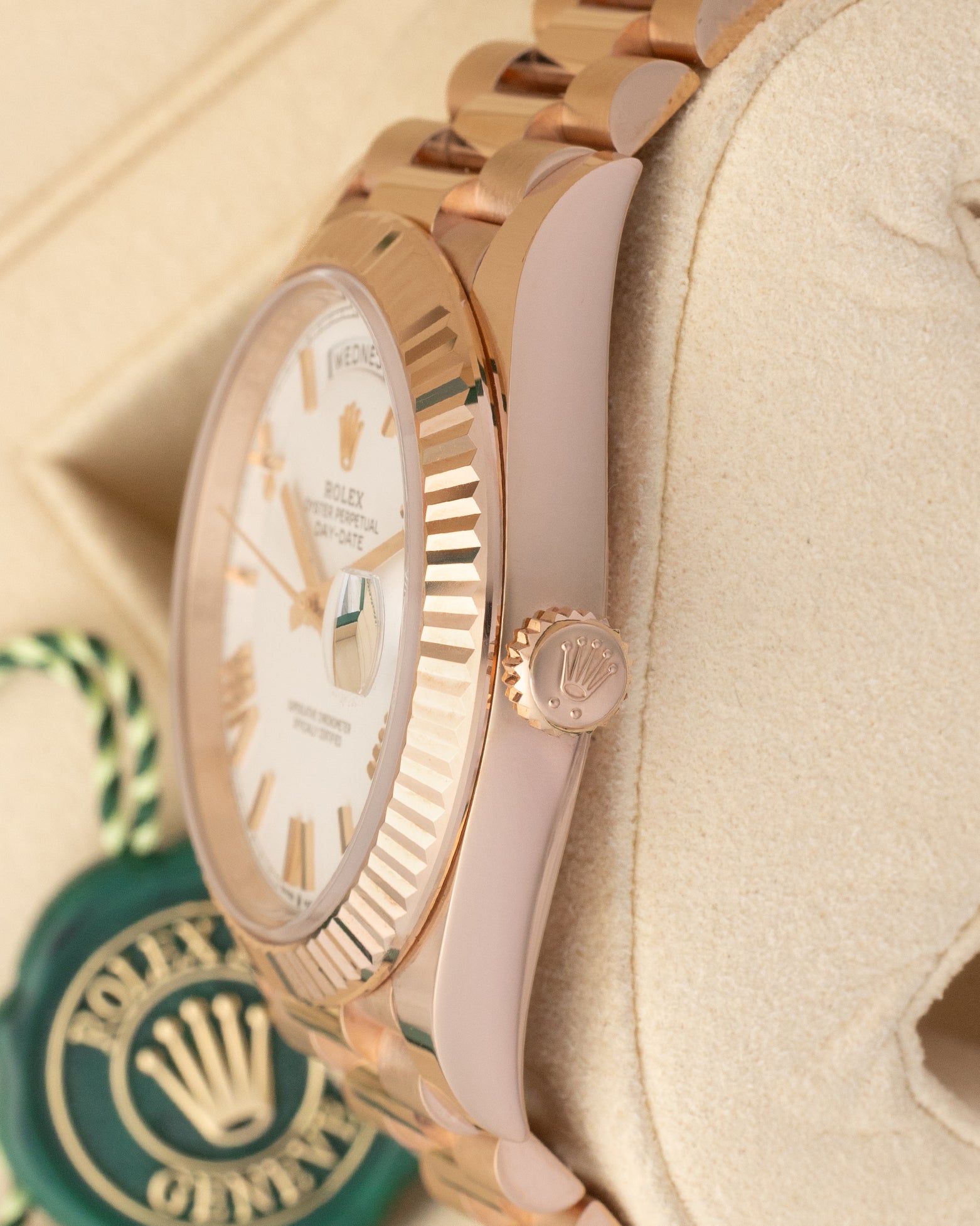 Close-up right profile view of the watch head focusing on the sharp coin-edge fluted bezel details, flat sapphire crystal, and the 18k Everose gold Twinlock winding crown