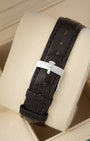 Rear view of the dark brown alligator grain leather strap secured with a polished steel tang buckle on the vintage Rolex watch