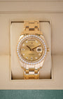 A Rolex Day-Date Special Edition Pearlmaster 39 reference 18948 in solid 18k yellow gold featuring a champagne dial, diamond hour markers, and a factory diamond-set bezel inside its box at Noah's Fine Watches & Jewelry in Dallas