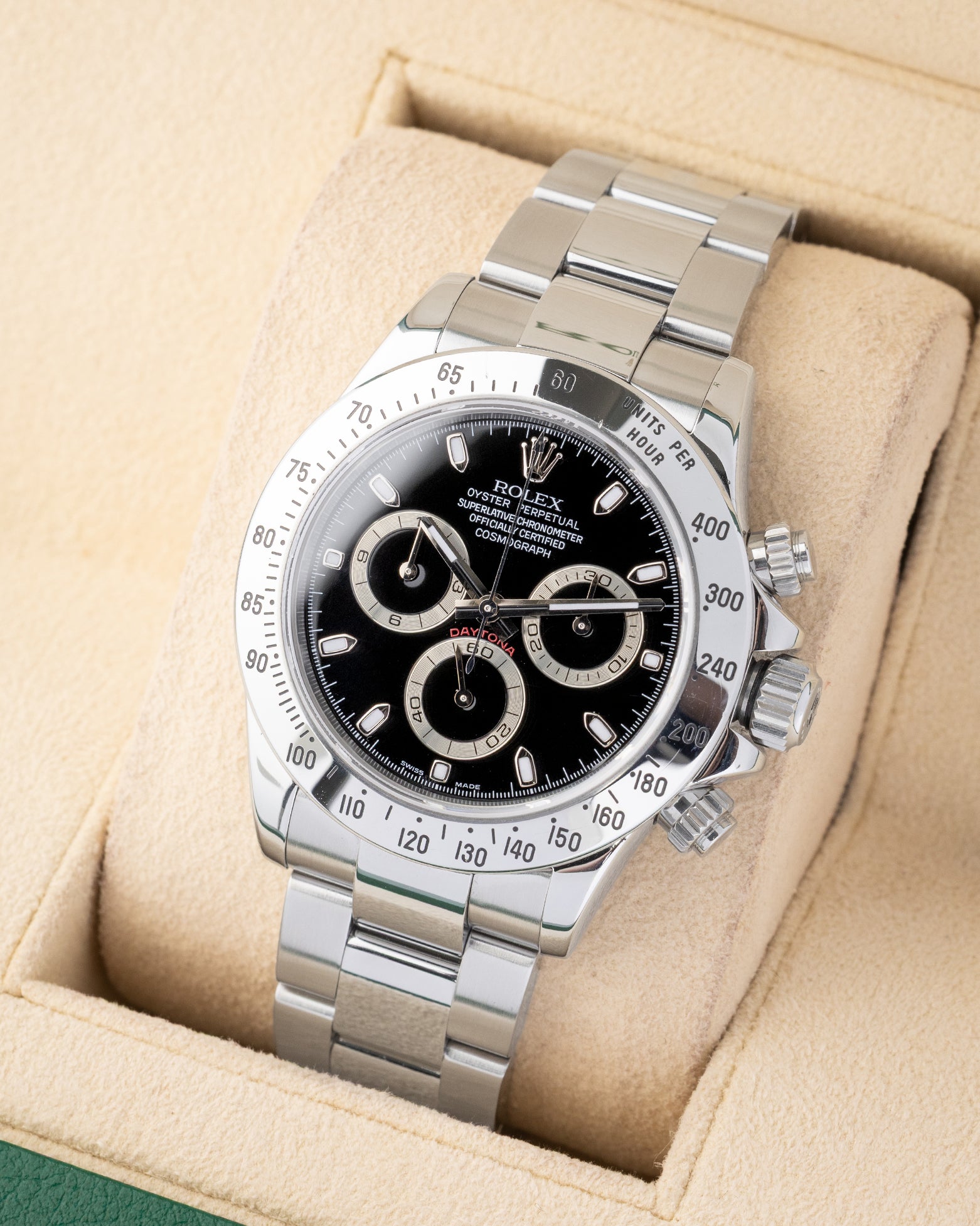 angled profile view of a pre-owned 2007 steel Rolex Daytona reference 116520 showcasing the black racing dial on its presentation cushion