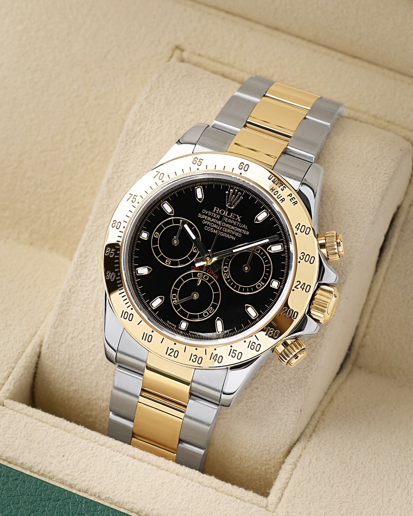 angled profile view of a pre-owned two-tone Rolex Daytona reference 116523 showcasing the black dial and steel and 18k yellow gold Oyster bracelet