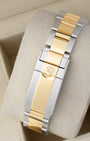 Rear view of the two-tone steel and yellow gold Oyster bracelet showing the folding Oysterlock safety clasp with the embossed Rolex crown coronet logo