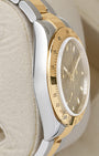 left-side case profile view of a pre-owned two-tone 40mm stainless steel and 18k gold Rolex Daytona Oyster case resting on a cushion