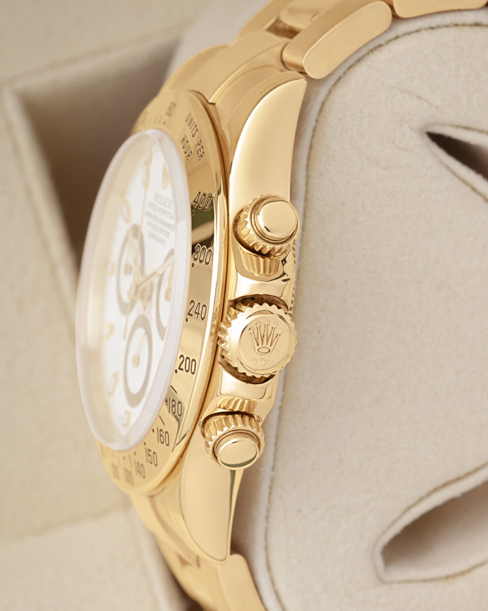 Side profile view of the 18k gold case showing the tachymeter bezel scale Triplock crown and threaded screw-down chronograph pushers