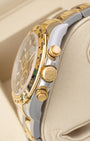 Side profile view showing 18k yellow gold crown, chronograph pushers, and Oystersteel case on Rolex Daytona 126503.