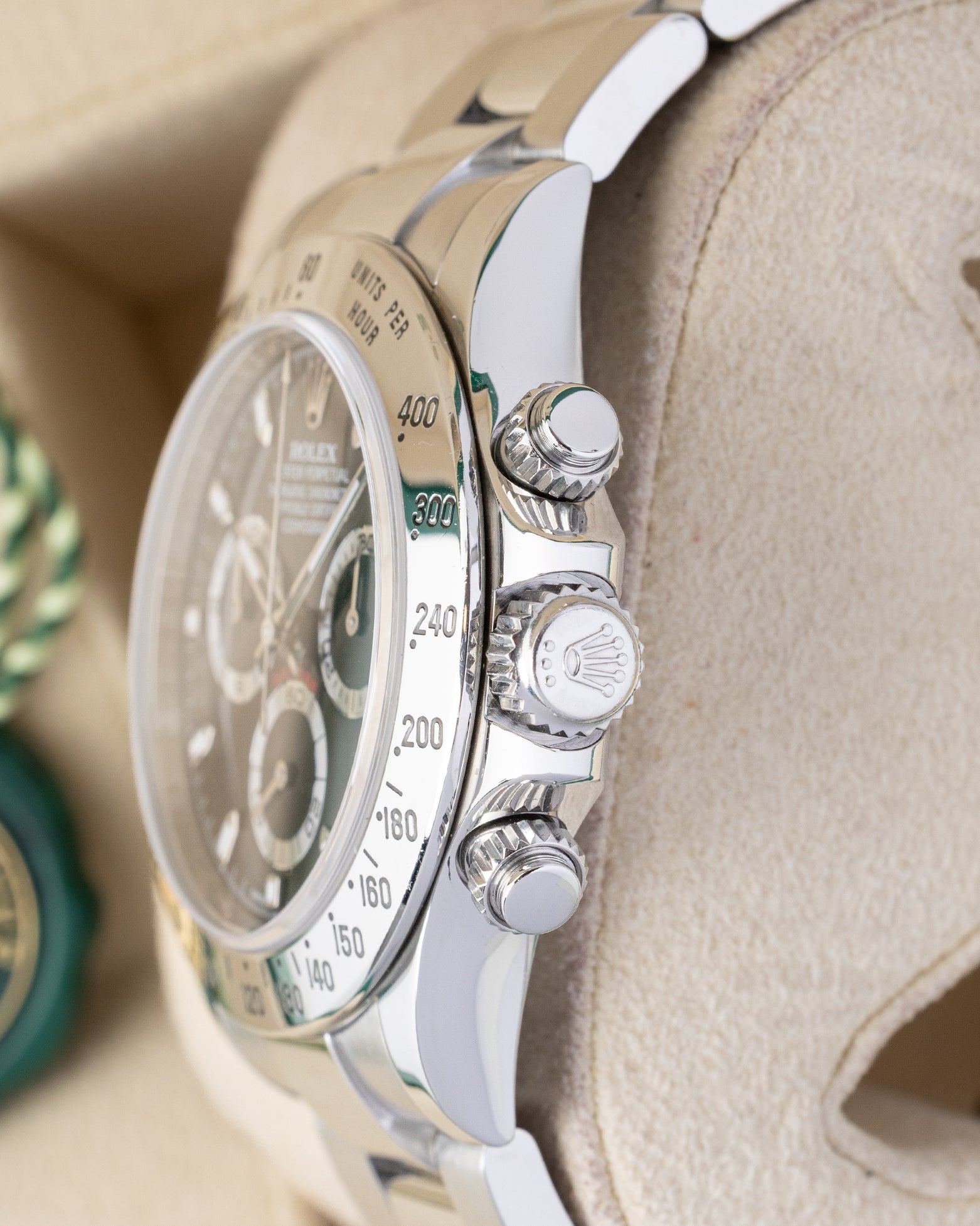 Polished stainless steel case profile view showcasing the screw-down chronograph pushers and Triplock winding crown on a 40mm Rolex Daytona