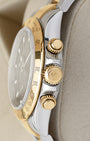 Two-tone case profile view showcasing the 18k yellow gold screw-down chronograph pushers and winding crown on a 40mm Rolex Daytona 116523