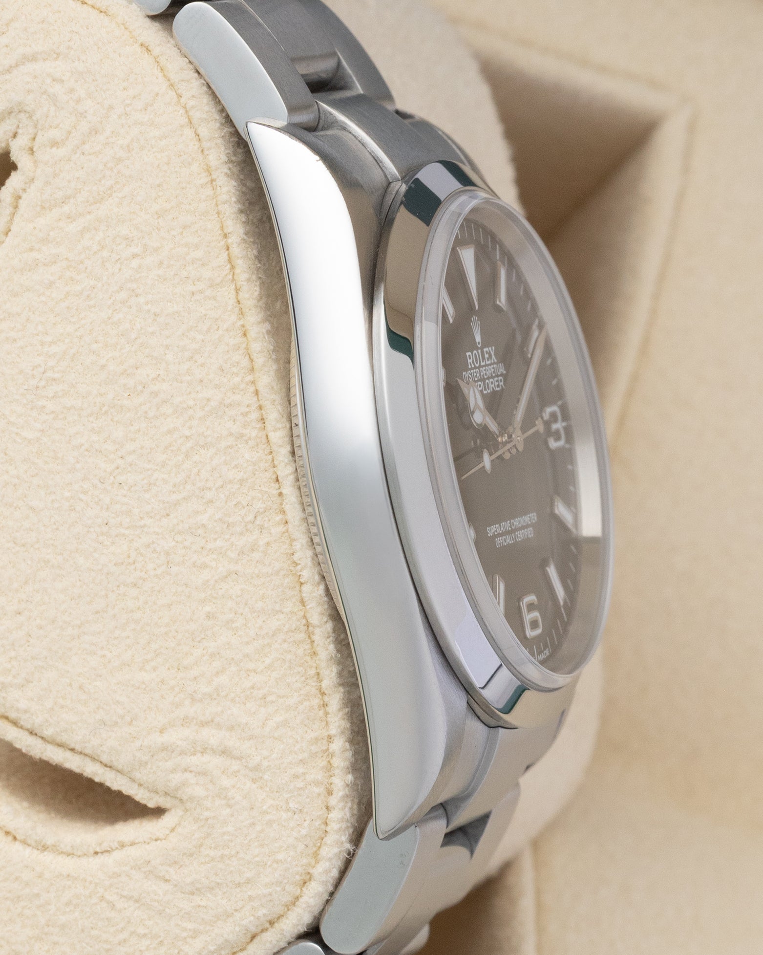 Left side profile view of the polished 36mm stainless steel case on a preowned Rolex Explorer reference 114270