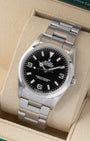 Angled front view of a vintage 2007 Rolex Explorer 114270 featuring a black dial and smooth bezel on an Oyster bracelet