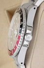 Side profile view of a stainless steel Rolex GMT-Master II case showing the crown guards, signed crown, and vintage style pierced lug holes