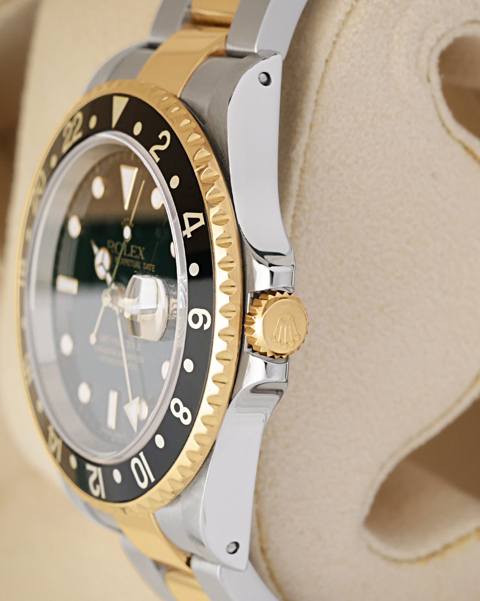 Side case profile focusing on the 18k yellow gold screw-down crown and protected guards of a 2004 two-tone Rolex GMT-Master II