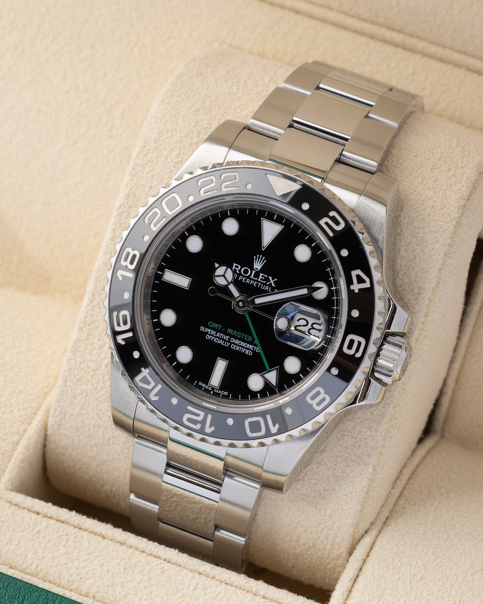 Angled front view of a preowned 2013 Rolex GMT-Master II 116710LN featuring a black dial, green 24-hour hand, and bidirectional black ceramic bezel