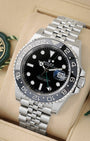 angled view of Rolex GMT-Master II 126710GRNR featuring green GMT hand, black and grey ceramic bezel, and Jubilee bracelet