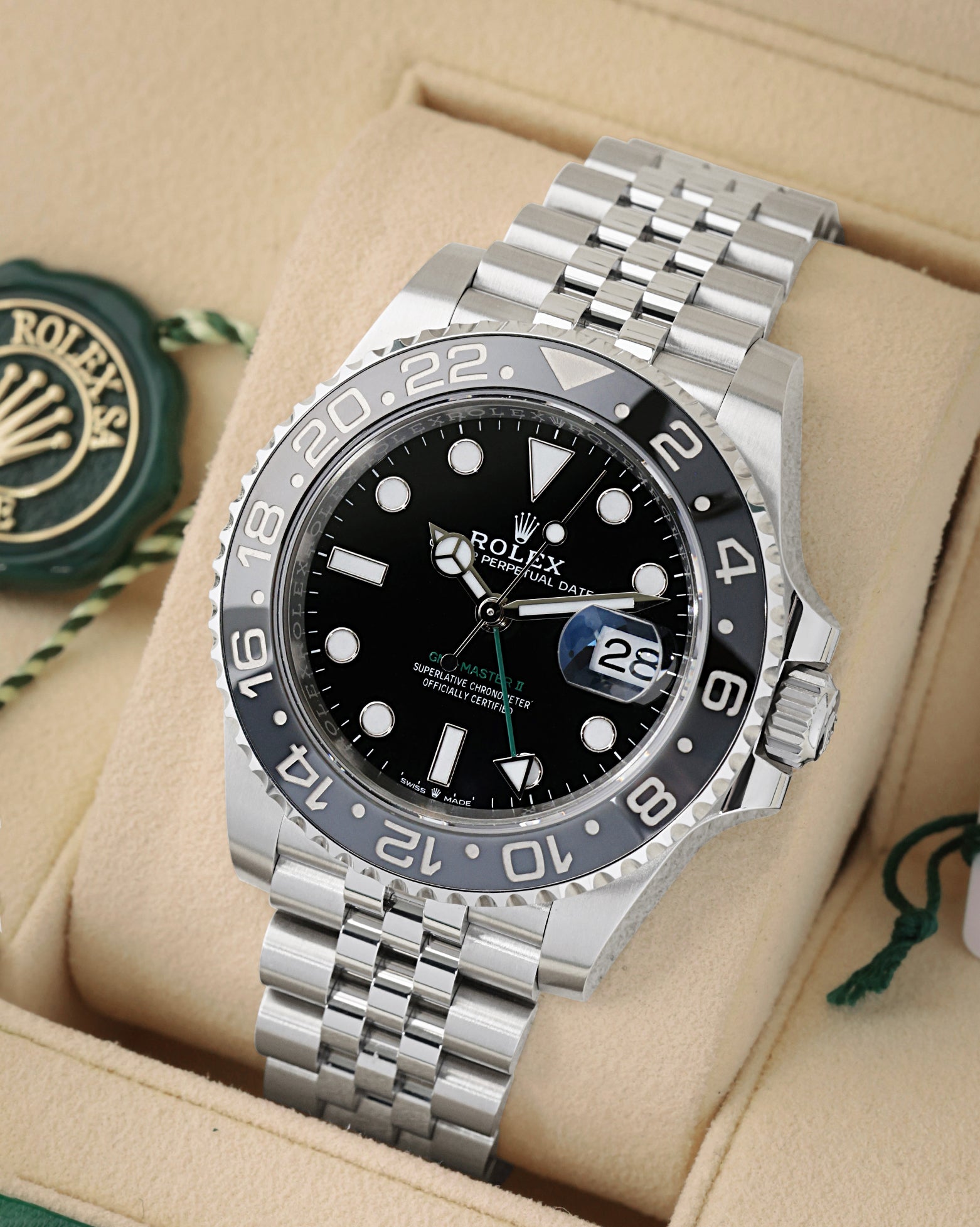 angled view of Rolex GMT-Master II 126710GRNR featuring green GMT hand, black and grey ceramic bezel, and Jubilee bracelet
