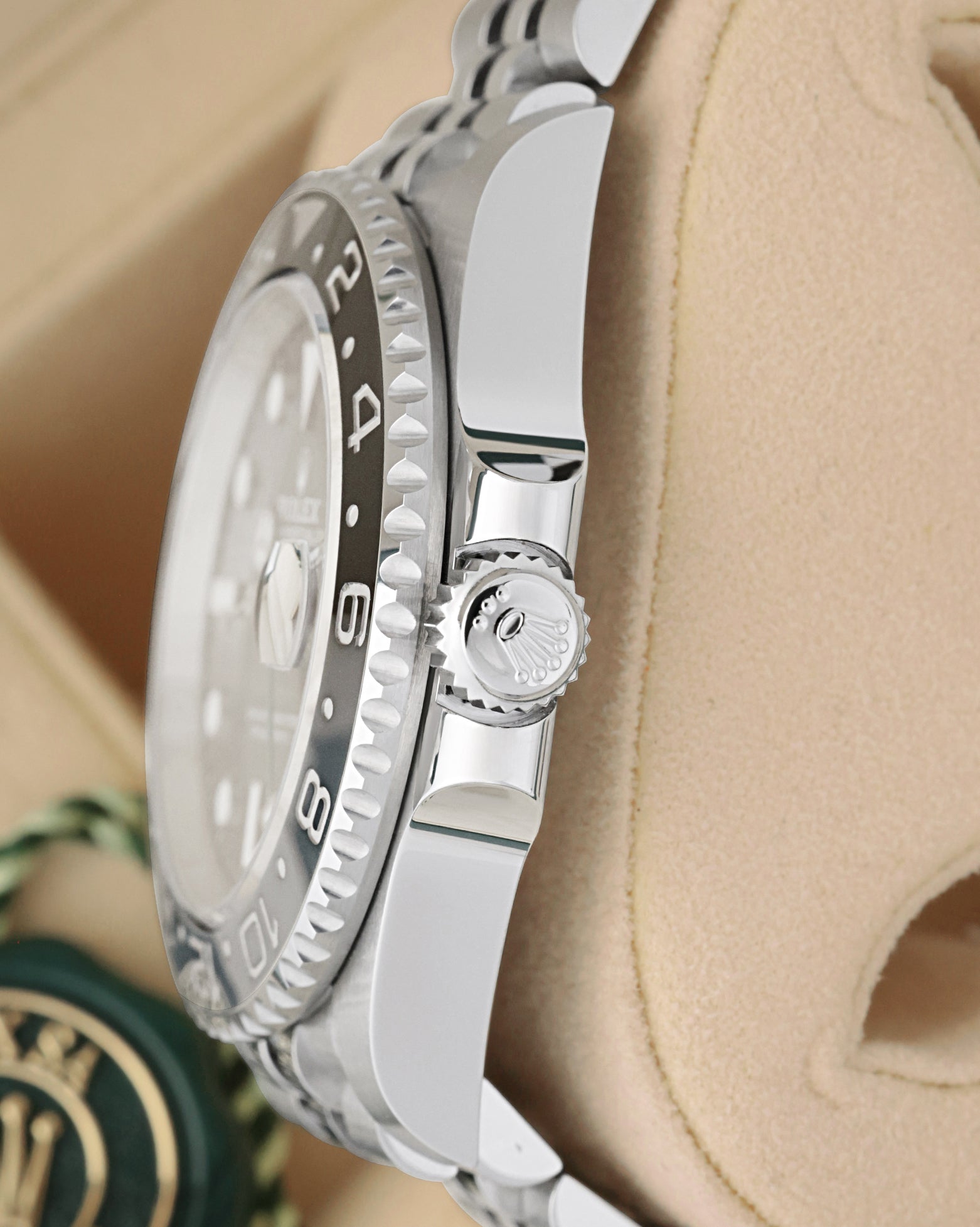 Side view close-up of the Triplock screw-down crown and bi-directional black/grey Cerachrom bezel on Rolex GMT-Master II 126710GRNR
