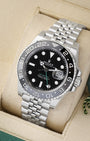 angled profile view of a pre-owned 2025 Rolex GMT-Master II reference 126710GRNR showcasing the black dial and stainless steel Jubilee bracelet