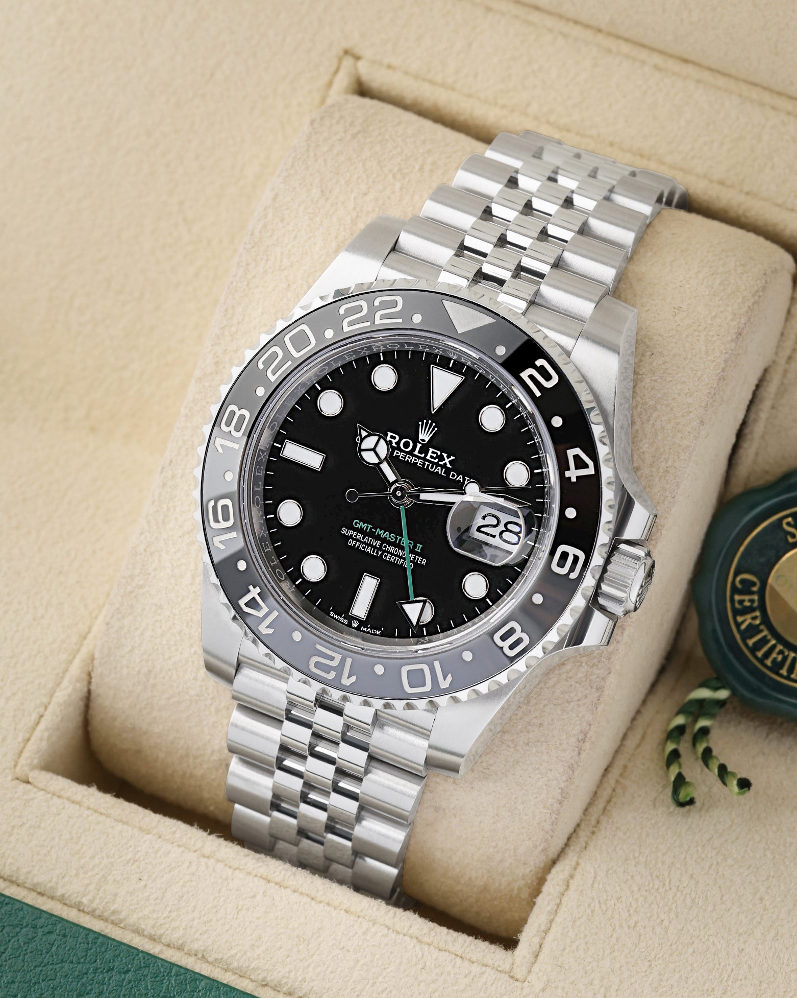 angled profile view of a pre-owned 2025 Rolex GMT-Master II reference 126710GRNR showcasing the black dial and stainless steel Jubilee bracelet