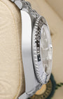 left-side case profile view of a pre-owned 40mm stainless steel Rolex GMT-Master II watch case resting on a presentation cushion