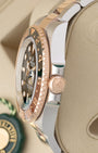 Side profile view displaying the 18k Everose gold Triplock winding crown and two-tone case on 2026 Rolex GMT-Master II Root Beer 126711CHNR