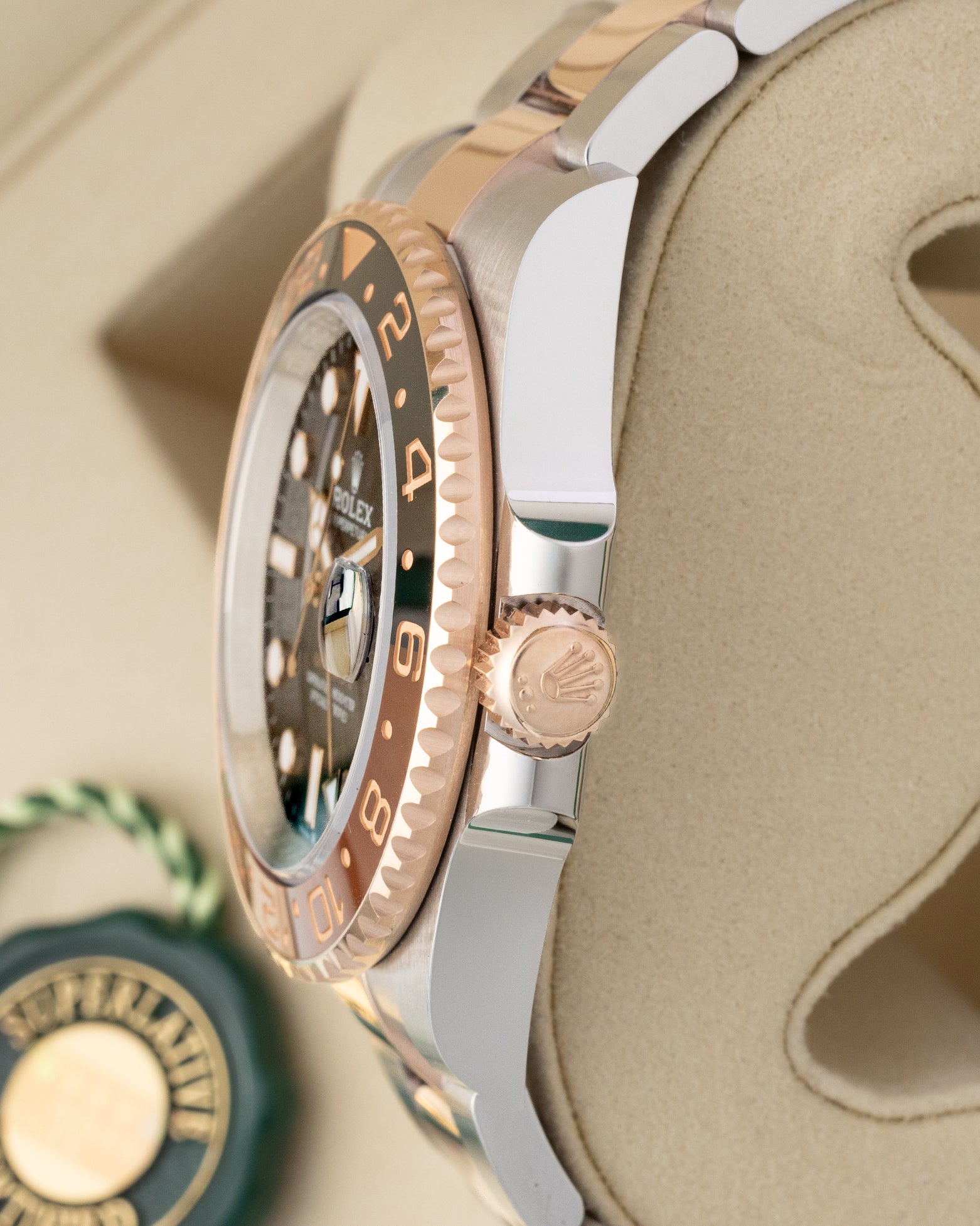 Side profile view displaying the 18k Everose gold Triplock winding crown and two-tone case on 2026 Rolex GMT-Master II Root Beer 126711CHNR