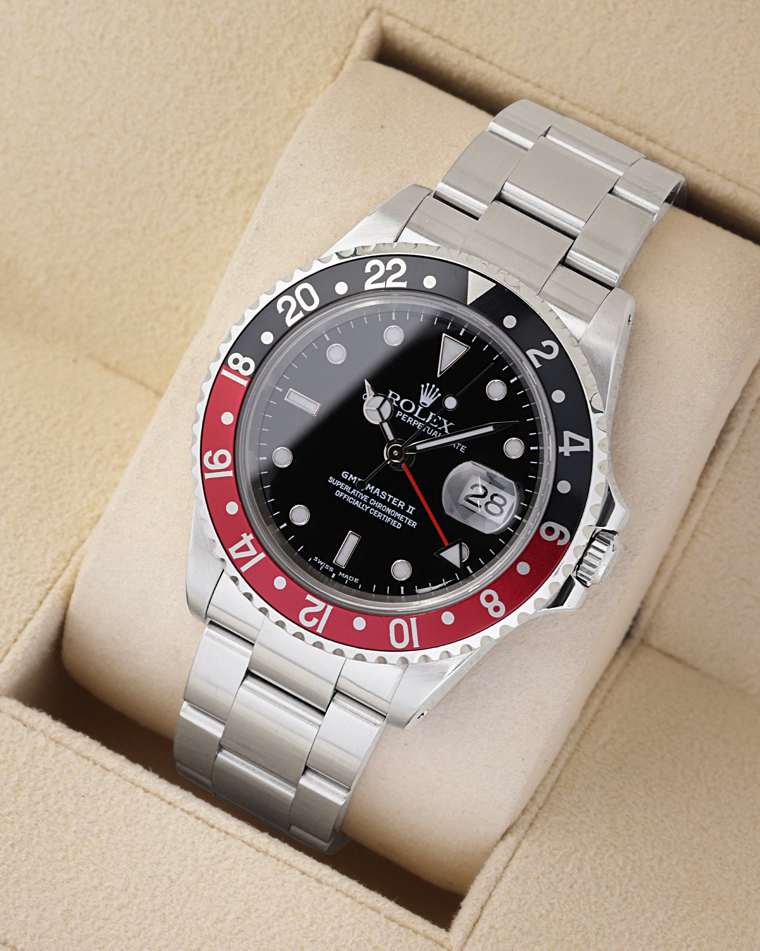 An angled studio profile shot of the stainless steel case and Oyster link bracelet of a Rolex GMT-Master II 16710 Coke