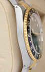 Left side perspective showcasing the high-polish finish on the stainless steel case side and the 18k yellow gold coin-edge bezel grip