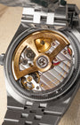 The reverse chassis profile viewed through a transparent sapphire caseback revealing the 5Hz high-frequency Rolex Caliber 7135 movement and its cut-out yellow gold oscillating weight