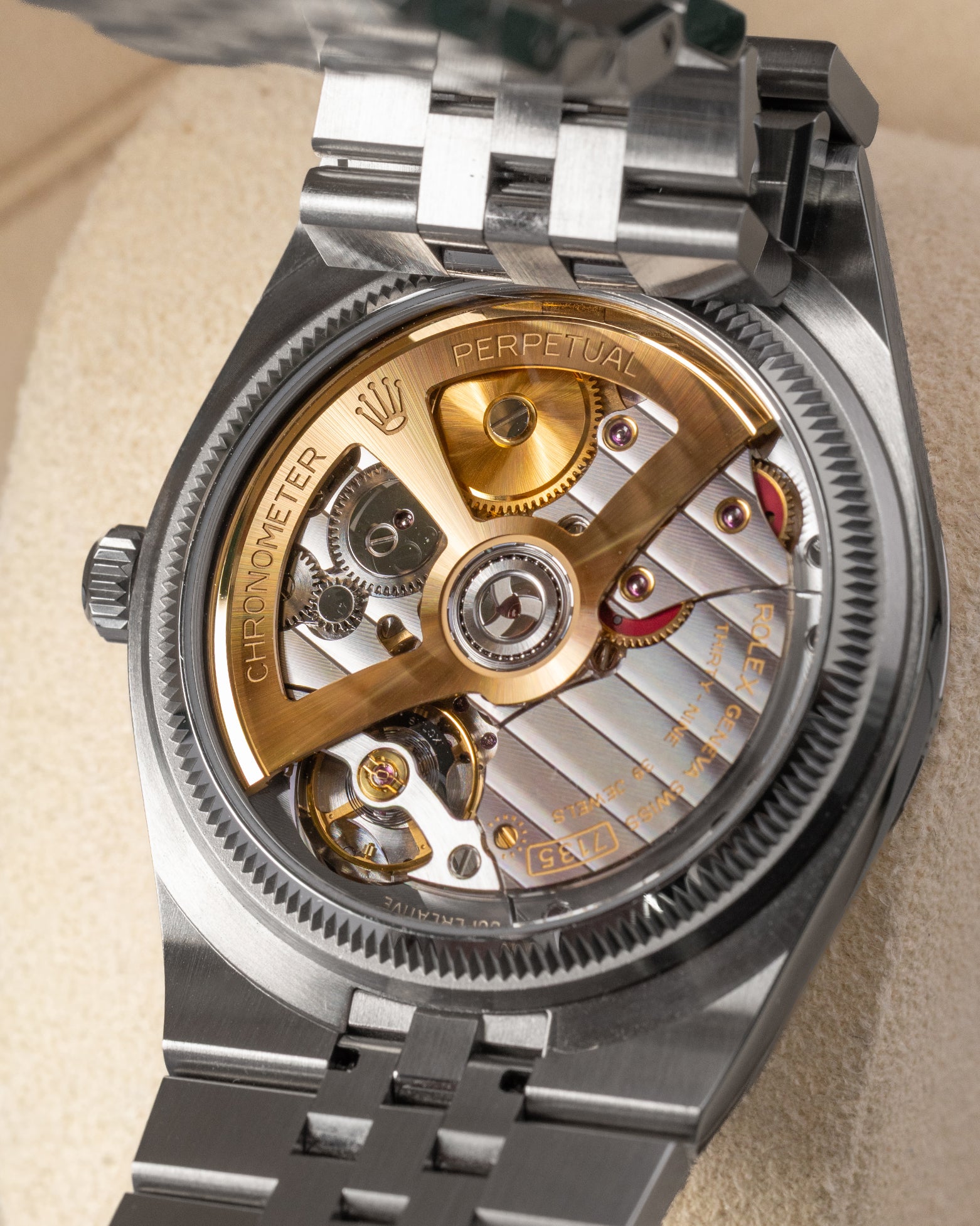 The reverse chassis profile viewed through a transparent sapphire caseback revealing the 5Hz high-frequency Rolex Caliber 7135 movement and its cut-out yellow gold oscillating weight