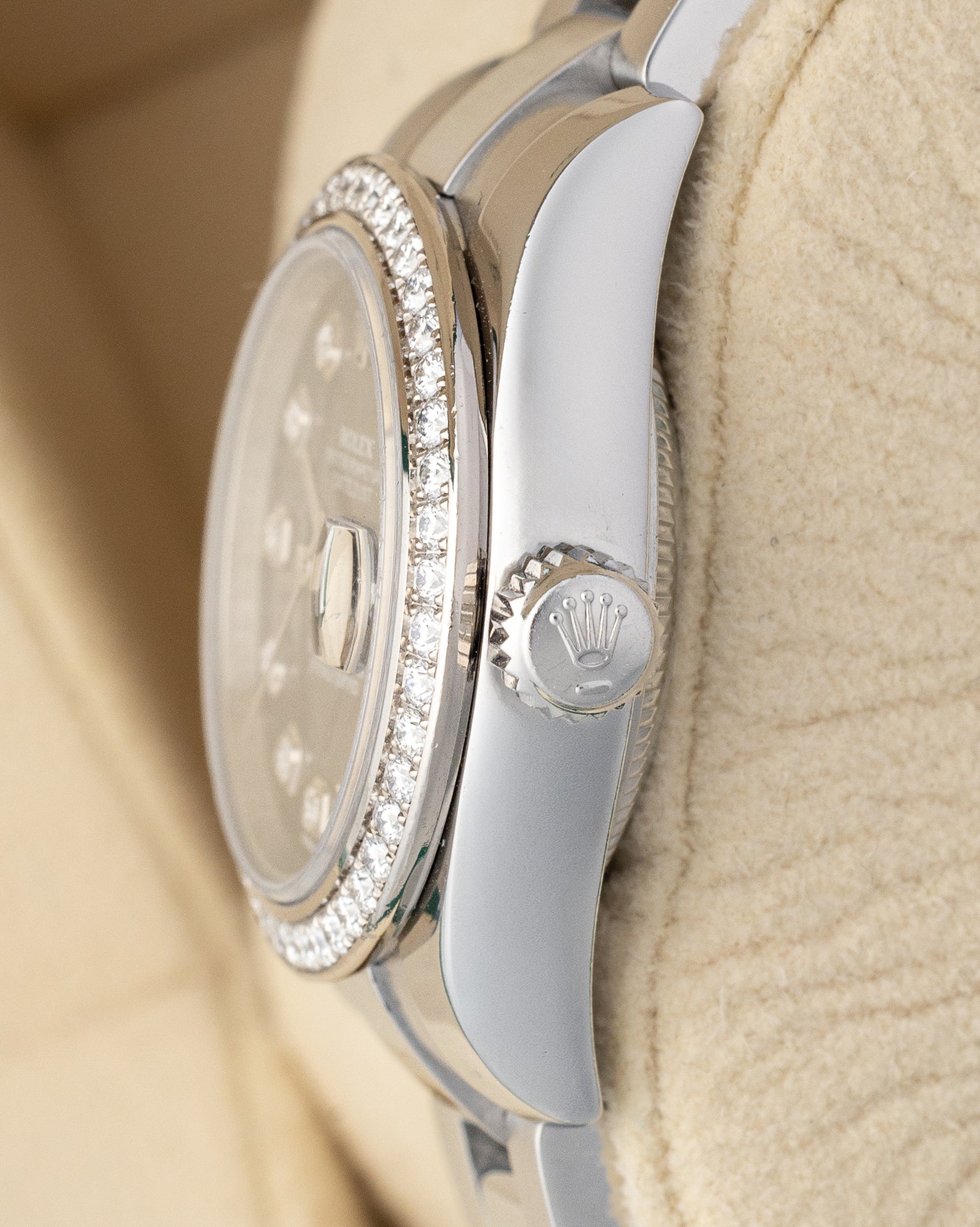 Close-up right profile view of the 26mm Rolex Lady-Datejust 179384 case highlighting the factory diamond-set bezel and winding crown
