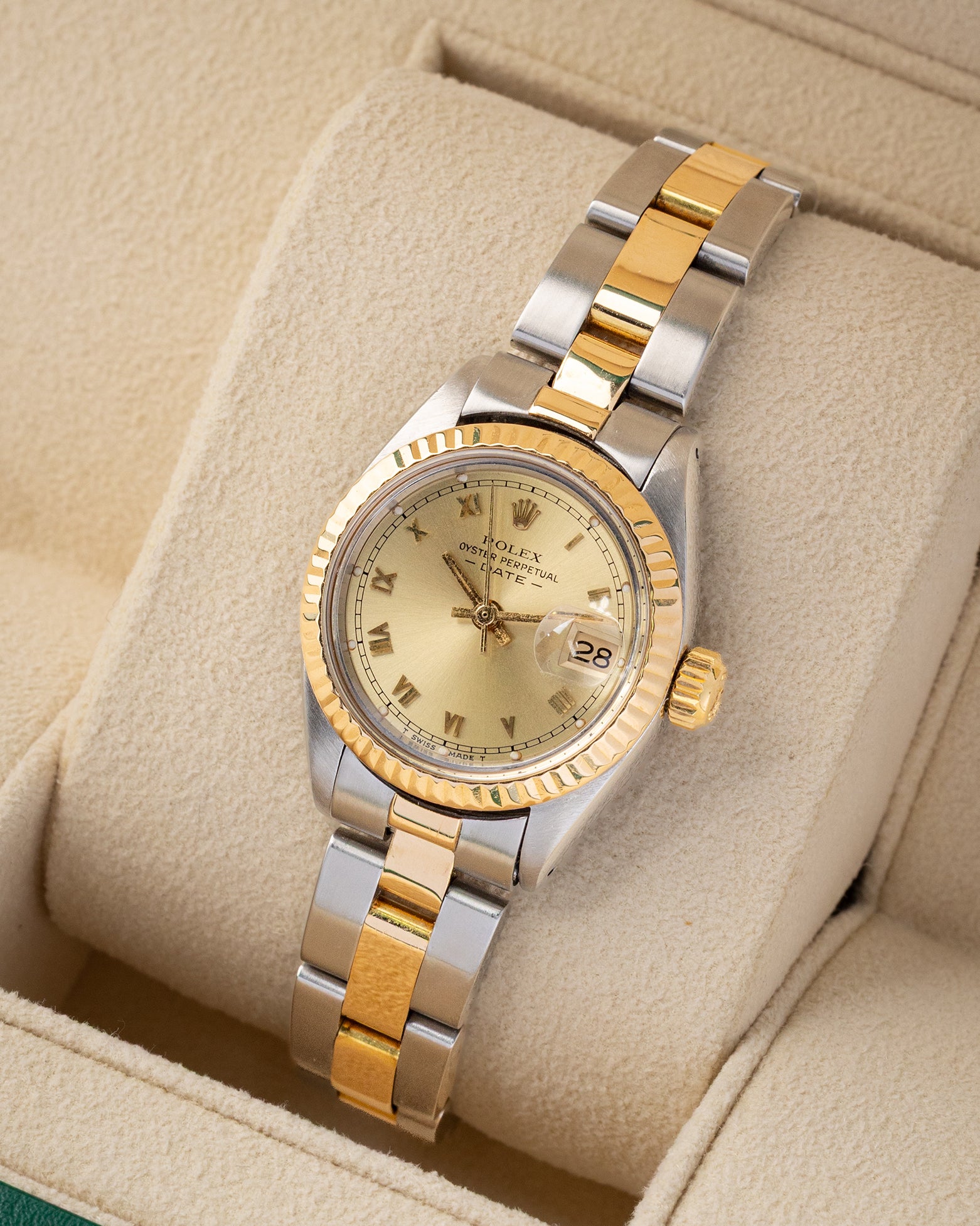 Angled view of a vintage 1981 Rolex Lady-Datejust 6916 featuring a champagne champagne dial, fluted bezel, and two-tone Oyster bracelet.
