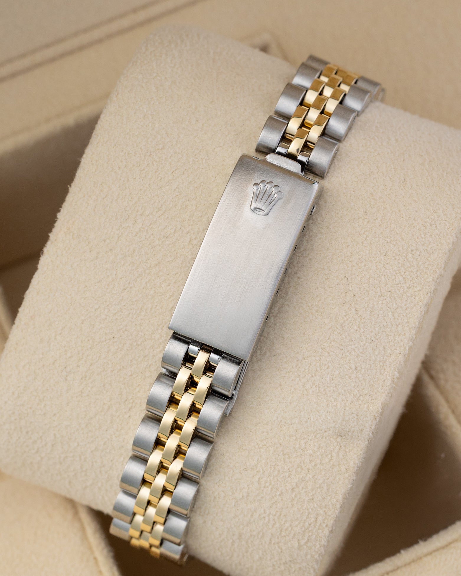 Stainless steel and yellow gold Jubilee folding clasp mounted on a beige watch cushion for the 1979 vintage Rolex Lady-Datejust 6917.