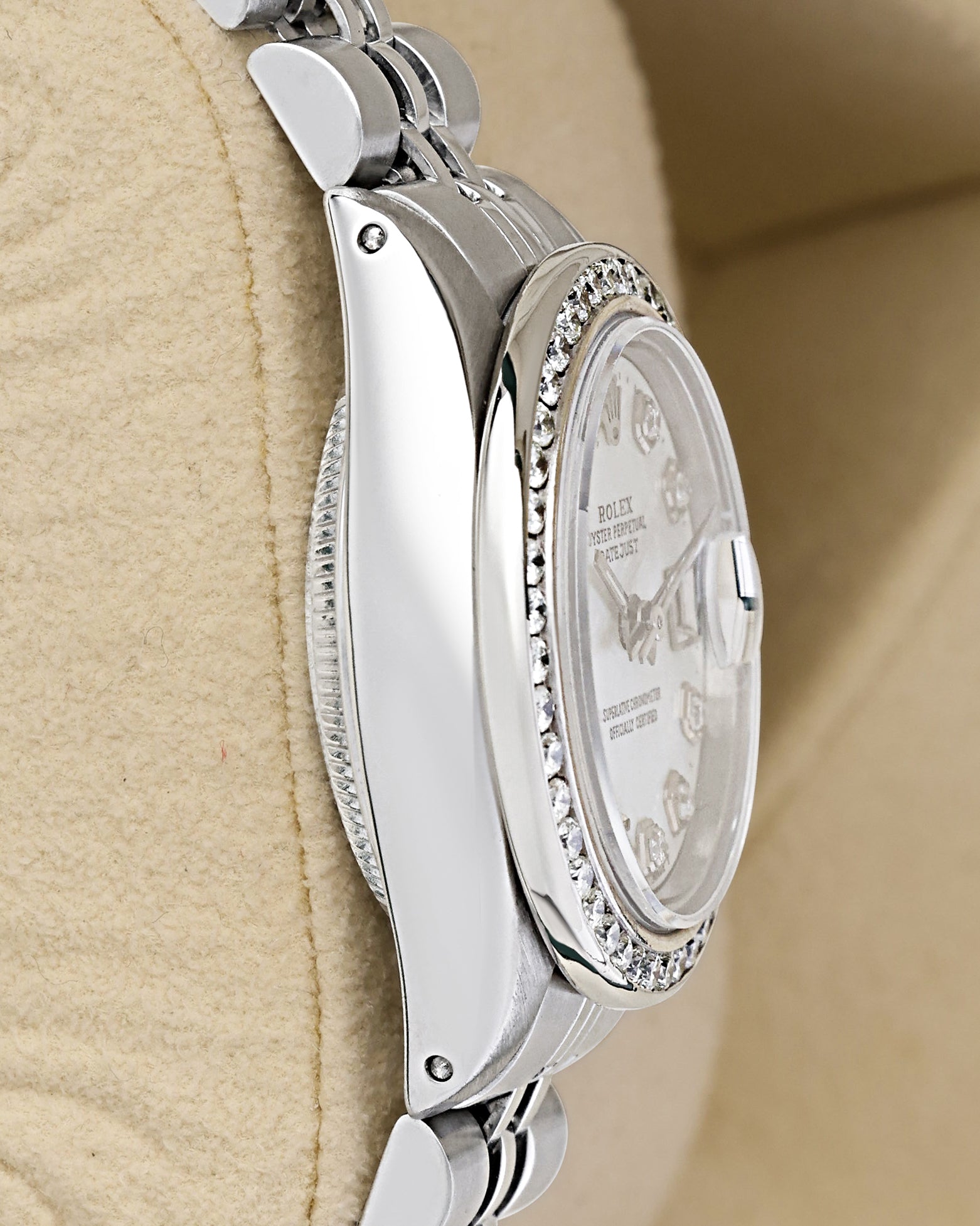 Polished left-side case profile view of a vintage stainless steel 26mm Rolex Oyster case resting on a presentation cushion