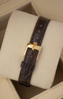 Dark brown leather strap and gold pin buckle mounted on a watch cushion for the 1984 vintage Rolex Lady-Datejust 69178.