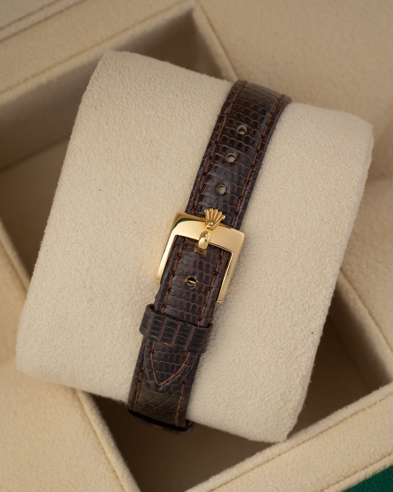 Dark brown leather strap and gold pin buckle mounted on a watch cushion for the 1984 vintage Rolex Lady-Datejust 69178.