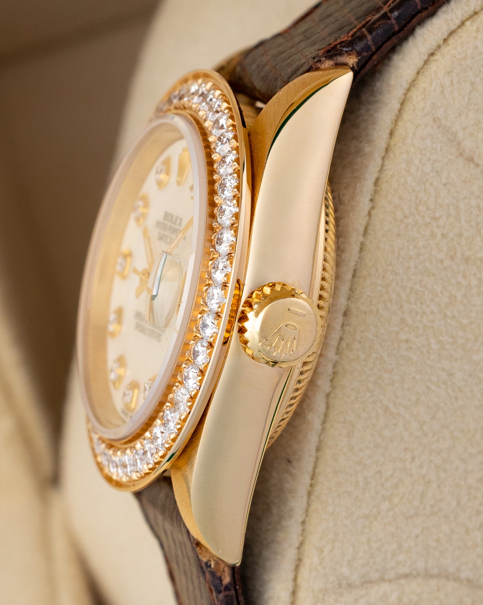 Side profile view of the 1984 vintage Rolex Lady-Datejust 69178 18k yellow gold case, diamond bezel edge, and gold winding crown.