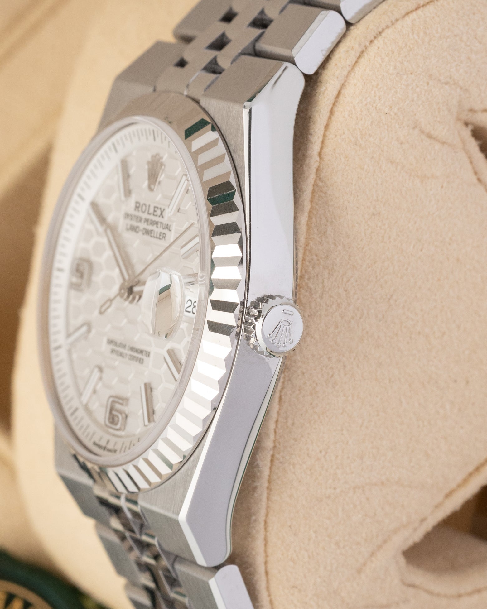 Close-up right profile view of the watch head highlighting the remarkably slim 9.6mm case height profile, the 18k white gold fluted bezel details, and the signed screw-down crown