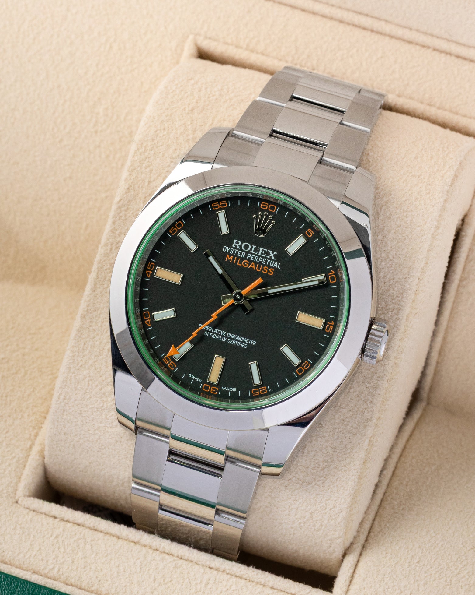 Angled front view of a preowned 2019 Rolex Milgauss 116400GV featuring a black dial, green glace sapphire crystal, and polished smooth bezel