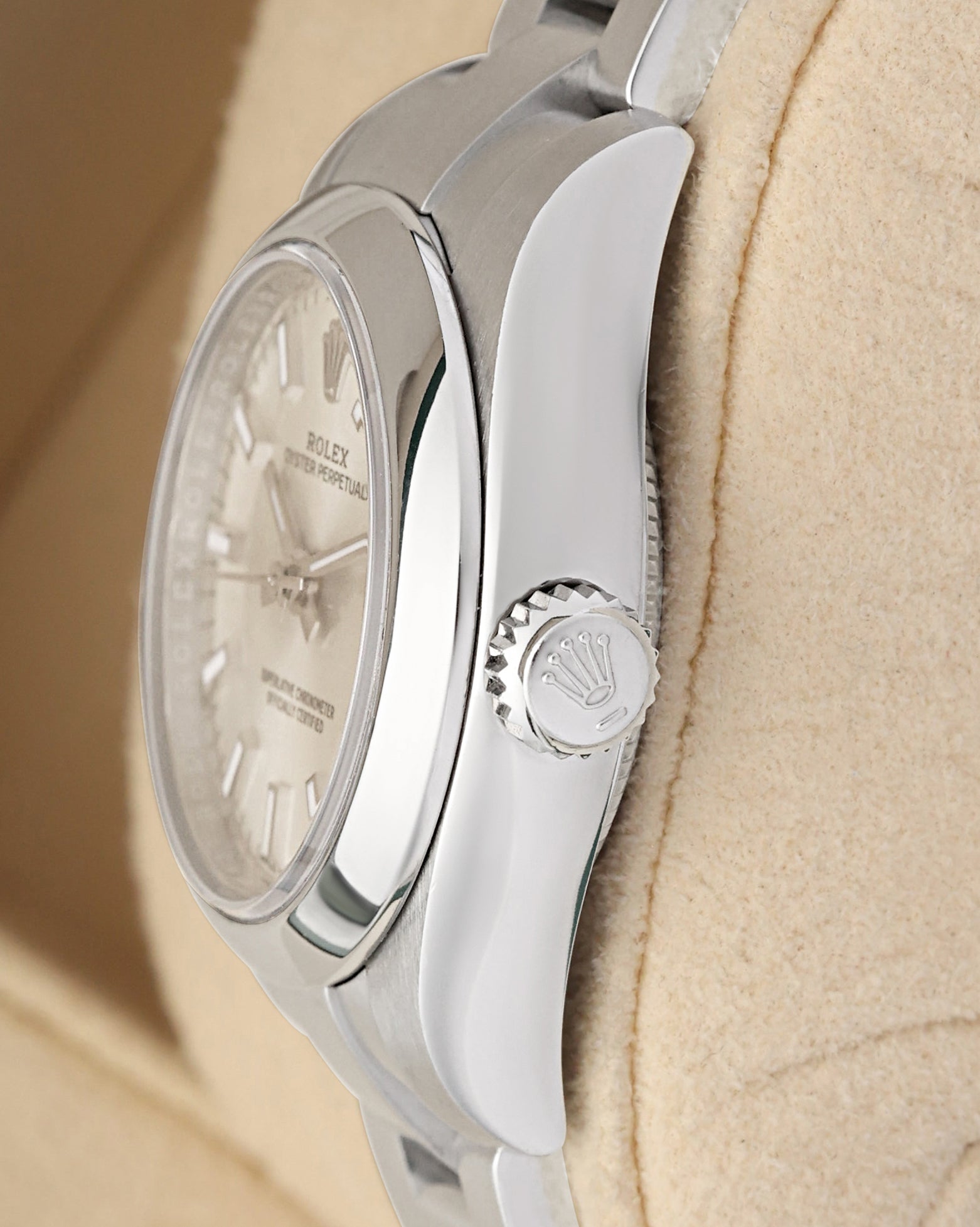Close-up right profile view of the slim watch head highlighting the smooth domed steel bezel edge, scratch-resistant sapphire crystal, and the fluted Twinlock screw-down winding crown