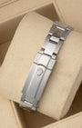 A rear view of the three-piece metal link watch band focusing on the secure closure of the folding Oysterclasp detailed with an embossed Rolex crown logo