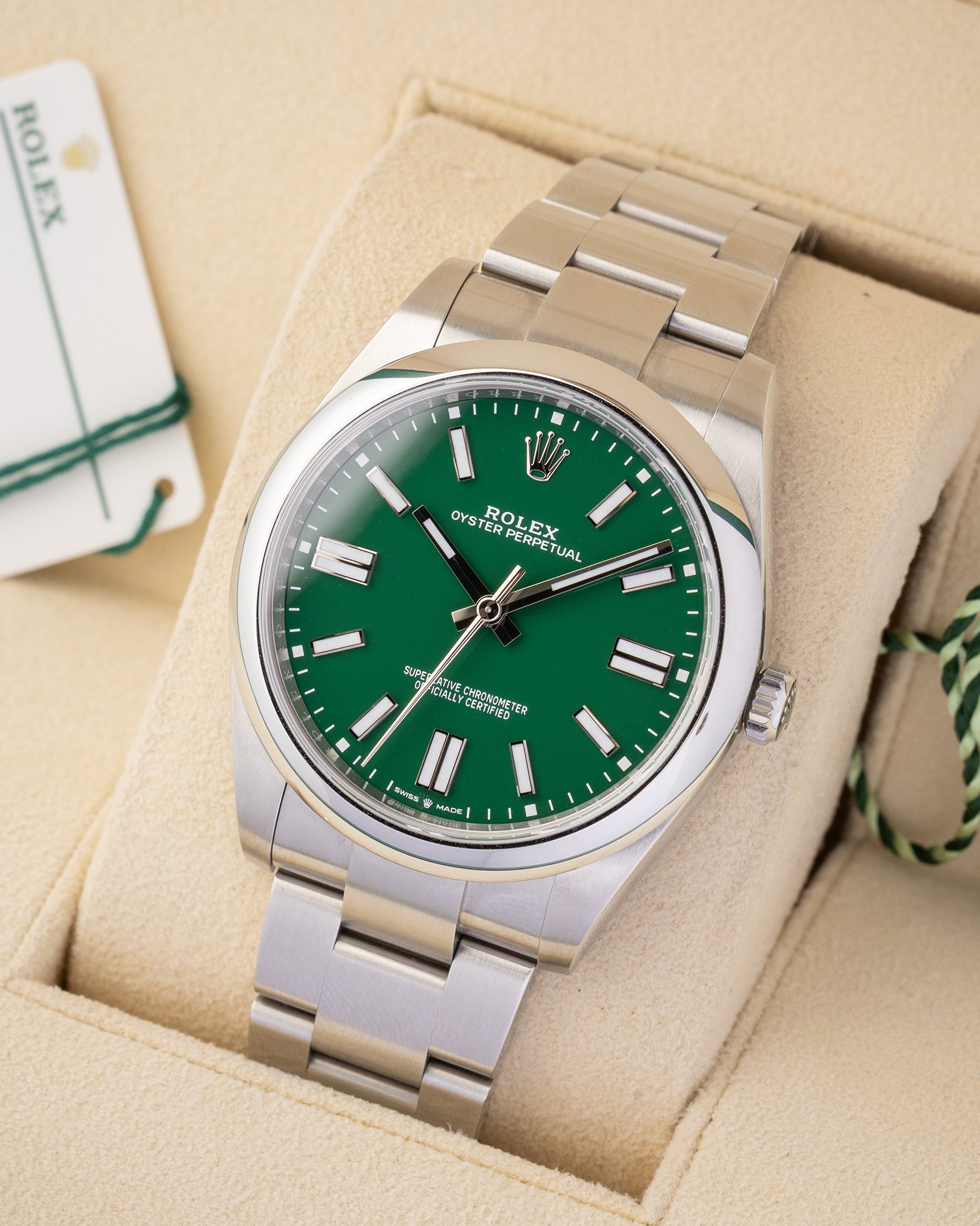Angled view of pre-owned 2022 Rolex Oyster Perpetual 41mm reference 124300 featuring a green dial and smooth steel bezel