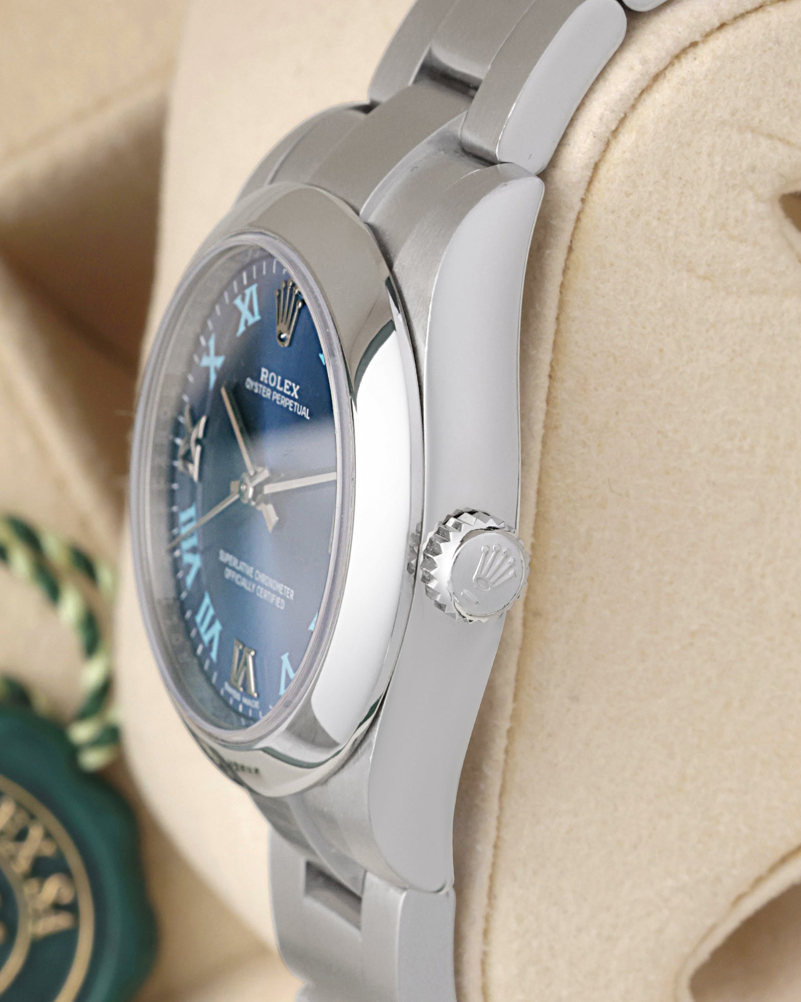Side profile view of the stainless steel Rolex 177200 case showing the smooth domed bezel and signed screw-down crown