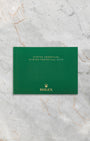 Official green Rolex Oyster Perpetual instruction booklet included with watch set at Noah's Fine Watches & Jewelry.