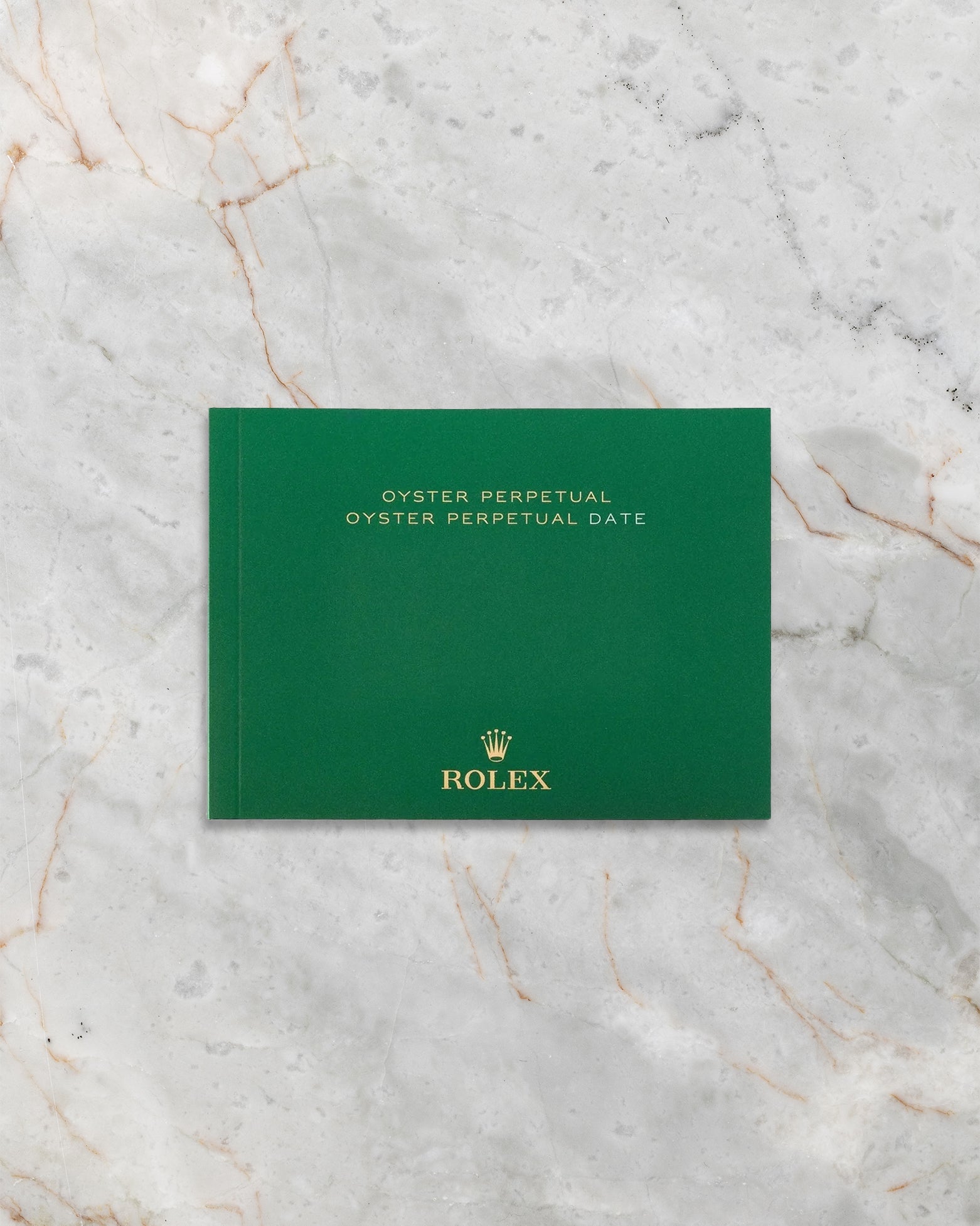 Official green Rolex Oyster Perpetual instruction booklet included with watch set at Noah's Fine Watches & Jewelry.